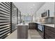 Modern kitchen with island, stainless appliances, stylish backsplash, and hardwood floors at 4072 W 17Th Ave, Denver, CO 80204