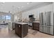 Open-concept kitchen with stainless steel appliances, white cabinetry, and a center island at 4072 W 17Th Ave, Denver, CO 80204