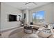 Light-filled living room features a large sectional, modern rug, and picturesque outdoor views at 4072 W 17Th Ave, Denver, CO 80204