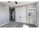 Comfortable bedroom with double doors, carpet, and open access to the on-suite bathroom and laundry at 56520 E 74Th Ave, Strasburg, CO 80136