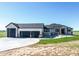A beautiful home showing a well manicured lawn and three car garage at 56520 E 74Th Ave, Strasburg, CO 80136