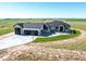 Stunning home with a sprawling driveway and a three-car garage, set against a serene landscape at 56520 E 74Th Ave, Strasburg, CO 80136