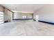 Spacious three-car garage with epoxy flooring and plenty of room for vehicles and storage at 56520 E 74Th Ave, Strasburg, CO 80136