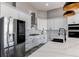 Modern kitchen with white cabinets, stainless steel appliances, and island with seating at 56520 E 74Th Ave, Strasburg, CO 80136