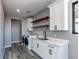Practical laundry room features a washer and dryer, white cabinets, and a sink with white countertop at 56520 E 74Th Ave, Strasburg, CO 80136