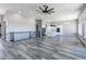 Bright open concept living area with kitchen and staircase at 56520 E 74Th Ave, Strasburg, CO 80136