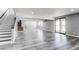 Expansive living room with hardwood flooring, natural light, and access to the outdoors at 56520 E 74Th Ave, Strasburg, CO 80136