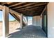 Open patio area with exposed ceiling and adjacent stairs at 56520 E 74Th Ave, Strasburg, CO 80136