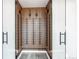 Wine cellar with vertical wine racks, glass doors, and accent lighting at 56520 E 74Th Ave, Strasburg, CO 80136