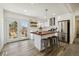 Modern kitchen featuring a kitchen island and French doors leading to a deck at 1549 S Telluride St, Aurora, CO 80017