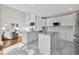 Bright, open kitchen with white cabinets, center island, and stainless steel appliances at 10103 Meadowbriar Ln, Highlands Ranch, CO 80126