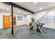 Basement gym with Cybex Arc Trainer and storage shelving at 127 Windwood Cir, Breckenridge, CO 80424