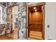 Convenient residential elevator with wood paneling and stone accent wall at 127 Windwood Cir, Breckenridge, CO 80424