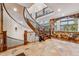 Stunning entryway showcasing a dramatic curved staircase and stone flooring at 127 Windwood Cir, Breckenridge, CO 80424