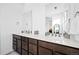 Bright bathroom featuring a dual vanity with sleek faucets and large mirrors for a modern, spacious feel at 15606 W Girard Ave, Morrison, CO 80465