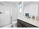 Bright bathroom featuring a glass shower, and modern countertop at 15606 W Girard Ave, Morrison, CO 80465