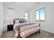 Comfortable bedroom features plush carpet, a decorative bed and plenty of natural light at 15606 W Girard Ave, Morrison, CO 80465