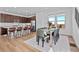 Open-concept dining area with modern furnishings, plenty of natural light and a view of the kitchen at 15606 W Girard Ave, Morrison, CO 80465