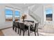 Bright dining room with seating for eight features hardwood floors and views from two large windows at 15606 W Girard Ave, Morrison, CO 80465
