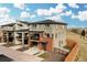 Beautiful three-story home featuring a brick and stone exterior, attached two-car garage, and landscaped front yard at 15606 W Girard Ave, Morrison, CO 80465