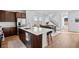 Bright kitchen features a large island, stainless steel appliances and opens to the dining area with scenic views at 15606 W Girard Ave, Morrison, CO 80465
