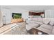 Bright living room with modern furnishings, a large sectional sofa, and an open layout flowing into the kitchen at 15606 W Girard Ave, Morrison, CO 80465