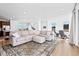 Spacious living room with a large sectional couch and scenic views from the many windows at 15606 W Girard Ave, Morrison, CO 80465