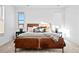 Bright main bedroom with plush carpet, large windows, and a stylish leather platform bed at 15606 W Girard Ave, Morrison, CO 80465
