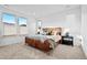 Spacious main bedroom with plush carpet, ample natural light, and a stylish leather platform bed at 15606 W Girard Ave, Morrison, CO 80465
