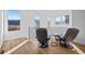Bright sitting area with wood floors features comfortable chairs and scenic views from three large windows at 15606 W Girard Ave, Morrison, CO 80465