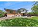 Expansive backyard with patio, landscaping, brick house, and plenty of sunshine at 13390 W Warren Ave, Lakewood, CO 80228