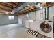 Unfinished basement laundry area with newer washer and dryer hookups ready for new owner at 13390 W Warren Ave, Lakewood, CO 80228