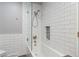 Clean bathroom showcasing new subway tiles in shower with a glass door and mosaic tiled niche at 13390 W Warren Ave, Lakewood, CO 80228