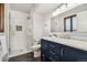 Bathroom features updated vanity, modern fixtures, and a glass shower at 13390 W Warren Ave, Lakewood, CO 80228