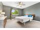 Cozy bedroom with gray walls, ceiling fan, window and a comfortable queen sized bed at 13390 W Warren Ave, Lakewood, CO 80228