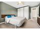 Serene bedroom with a platform bed, built-in closet and a full view door at 13390 W Warren Ave, Lakewood, CO 80228