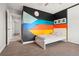 Bright bedroom featuring colorful wall art, neutral carpet, and closet space at 13390 W Warren Ave, Lakewood, CO 80228