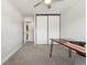 Bright home office with neutral walls, sleek desk, built in closet and natural light at 13390 W Warren Ave, Lakewood, CO 80228