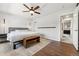 Comfortable bedroom featuring a ceiling fan, natural light, and hardwood floors at 13390 W Warren Ave, Lakewood, CO 80228