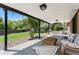 Enjoy an open covered patio area with neutral tones and a lovely view of the green backyard at 13390 W Warren Ave, Lakewood, CO 80228