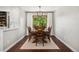 Elegant dining room with hardwood floors, a modern chandelier, and large windows at 13390 W Warren Ave, Lakewood, CO 80228