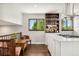 Upstairs dining room with hardwood floors, bar shelving, and large windows with a view at 13390 W Warren Ave, Lakewood, CO 80228