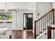 Inviting foyer with hardwood floors, staircase, and a stylish front door with decorative glass accents at 13390 W Warren Ave, Lakewood, CO 80228