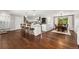 Spacious open concept kitchen flowing into a dining area with hardwood floors and modern lighting at 13390 W Warren Ave, Lakewood, CO 80228
