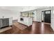 Bright kitchen with stainless steel appliances, hardwood floors, and a center island with seating at 13390 W Warren Ave, Lakewood, CO 80228