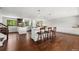 Open-concept kitchen featuring a large island with bar seating, stainless appliances, and hardwood floors at 13390 W Warren Ave, Lakewood, CO 80228