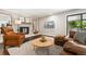 Cozy living room features modern decor, comfortable seating, and a brick fireplace at 13390 W Warren Ave, Lakewood, CO 80228