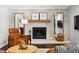 Inviting living room with brick fireplace, warm lighting, and comfortable seating arrangement at 13390 W Warren Ave, Lakewood, CO 80228