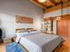 Bedroom with hardwood floors, a platform bed, and exposed wood beams at 1792 Wynkoop St # 508, Denver, CO 80202