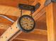 Charming clock from Parker and Son hangs from a beam with 